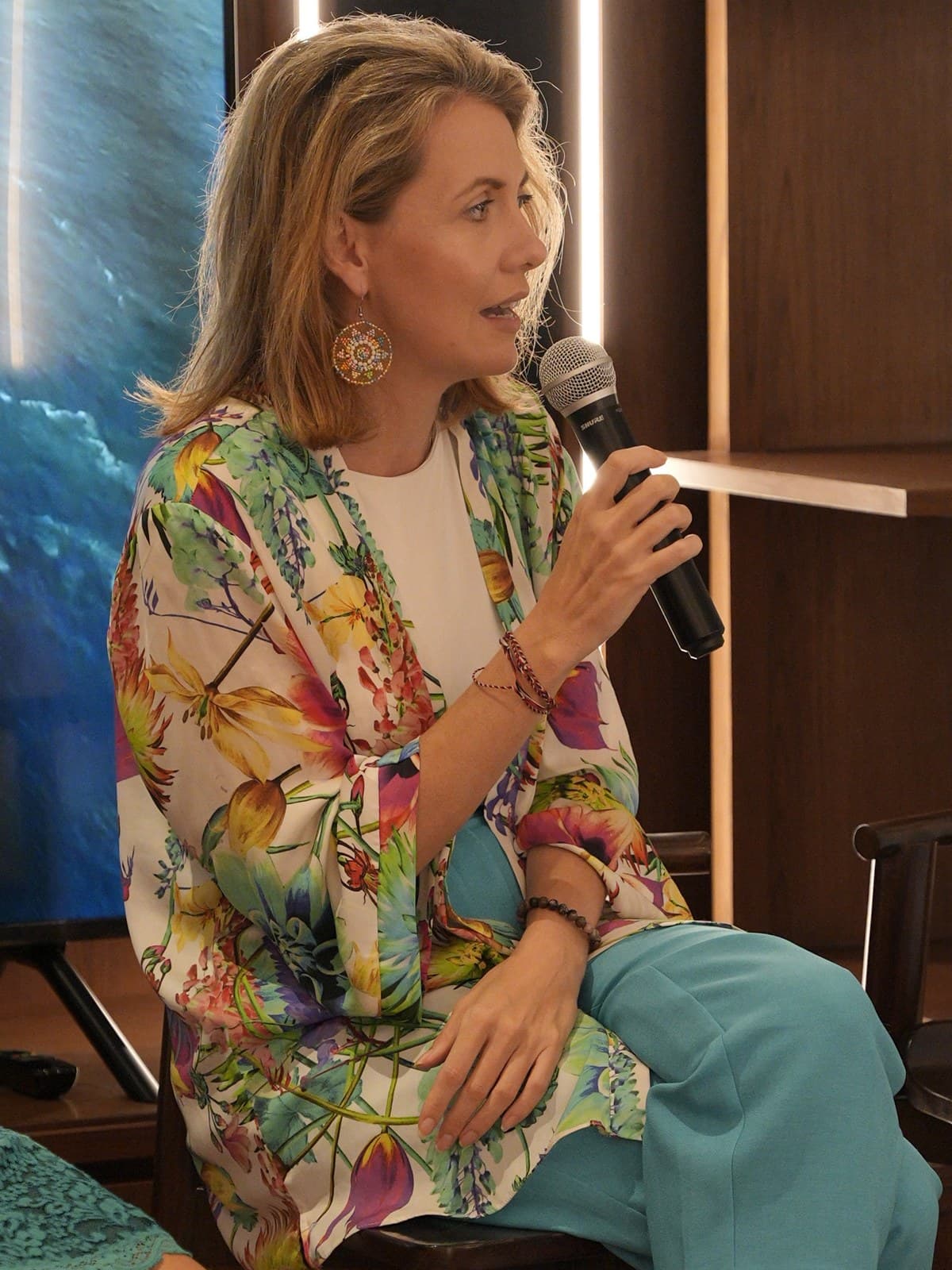 Kirsty Jayne Tait speaking into a microphone during a panel session